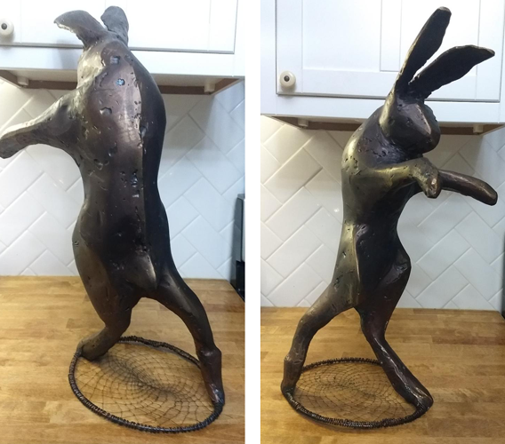 hare standing on a cobweb sculpture